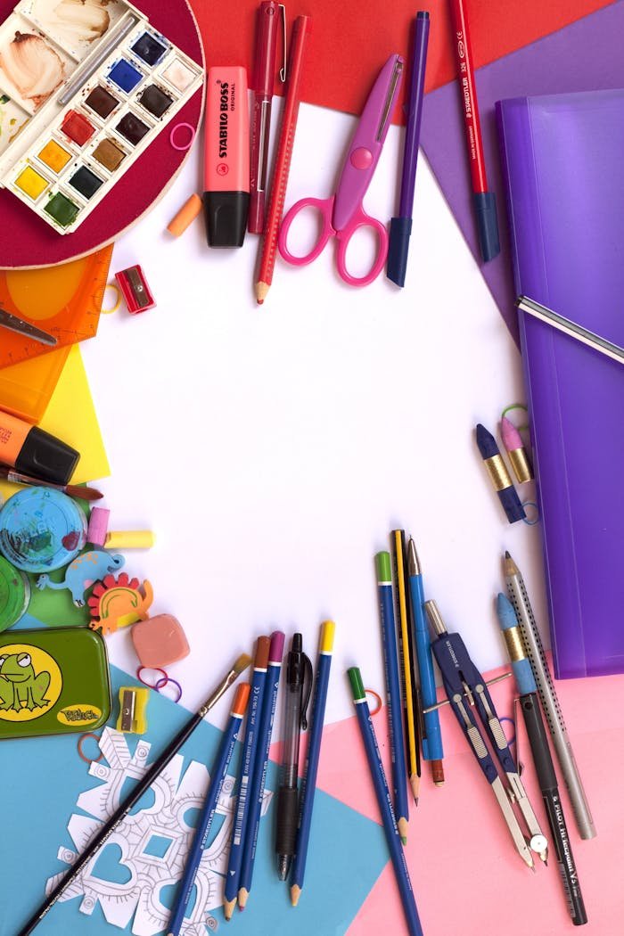 Vibrant collection of art and school supplies arranged in a flat lay. Perfect for educational themes.